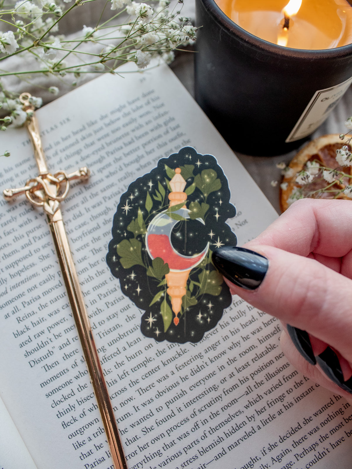 Flameroot waterproof sticker from Spark of the Everflame by Penn Cole from the Kindred's Curse Saga. A moon shaped bottle with red contents surrounded by foliage and magical bubbles, on a dark green solid background.