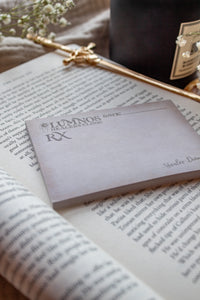 Spark of The Everflame Lumnos Healers Clinic RX Notepad. Inspired by the Kindreds Curse Saga by Penn Cole. This licensed 3"x4" post-it notepad looks like aged parchment, and has "Lumnos Healers Clinic - RX"  and a date line along the top then its signed off by Diem on the bottom corner.