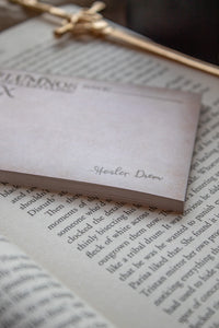 Spark of The Everflame Lumnos Healers Clinic RX Notepad. Inspired by the Kindreds Curse Saga by Penn Cole. This licensed 3"x4" post-it notepad looks like aged parchment, and has "Lumnos Healers Clinic - RX"  and a date line along the top then its signed off by Diem on the bottom corner.