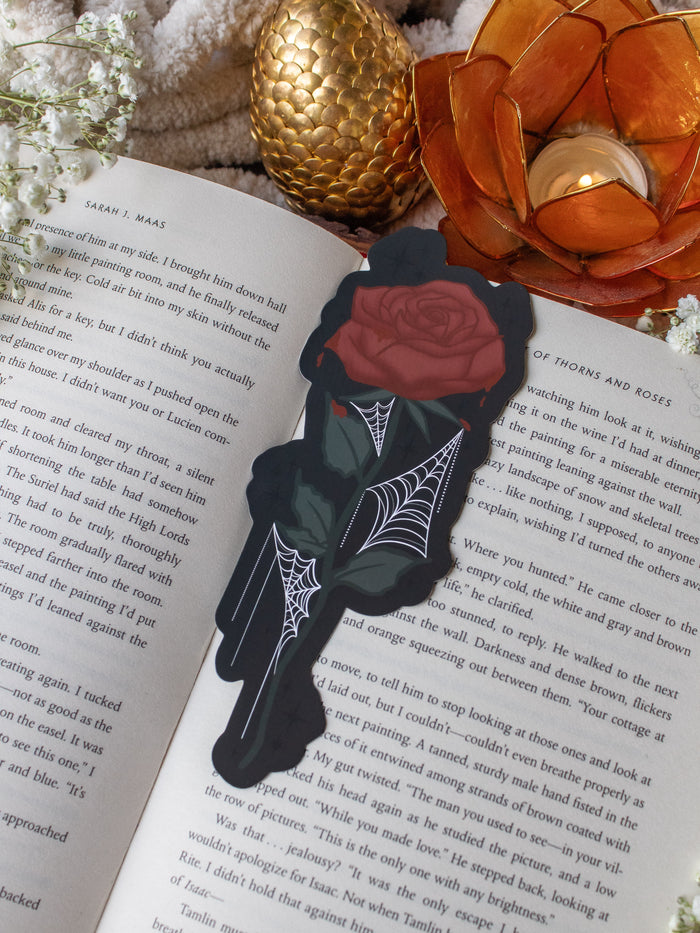 This bloody spooky Halloween rose is bright blood red with blood dripping off of it. It has little spiderwebs throughout the leaves on the stem.