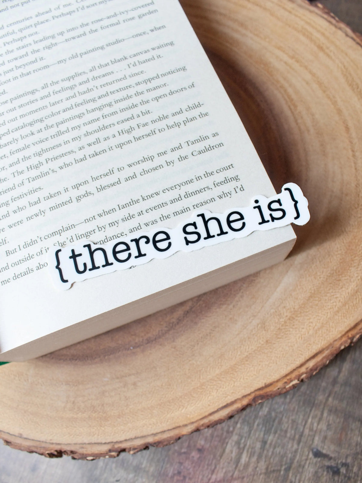 This There She Is sticker from The Serpent and The Wings of Night from the Crowns of Nyaxia Series by Carissa Broadbent is officially licensed. It features the text {there she is} in black on a solid white background