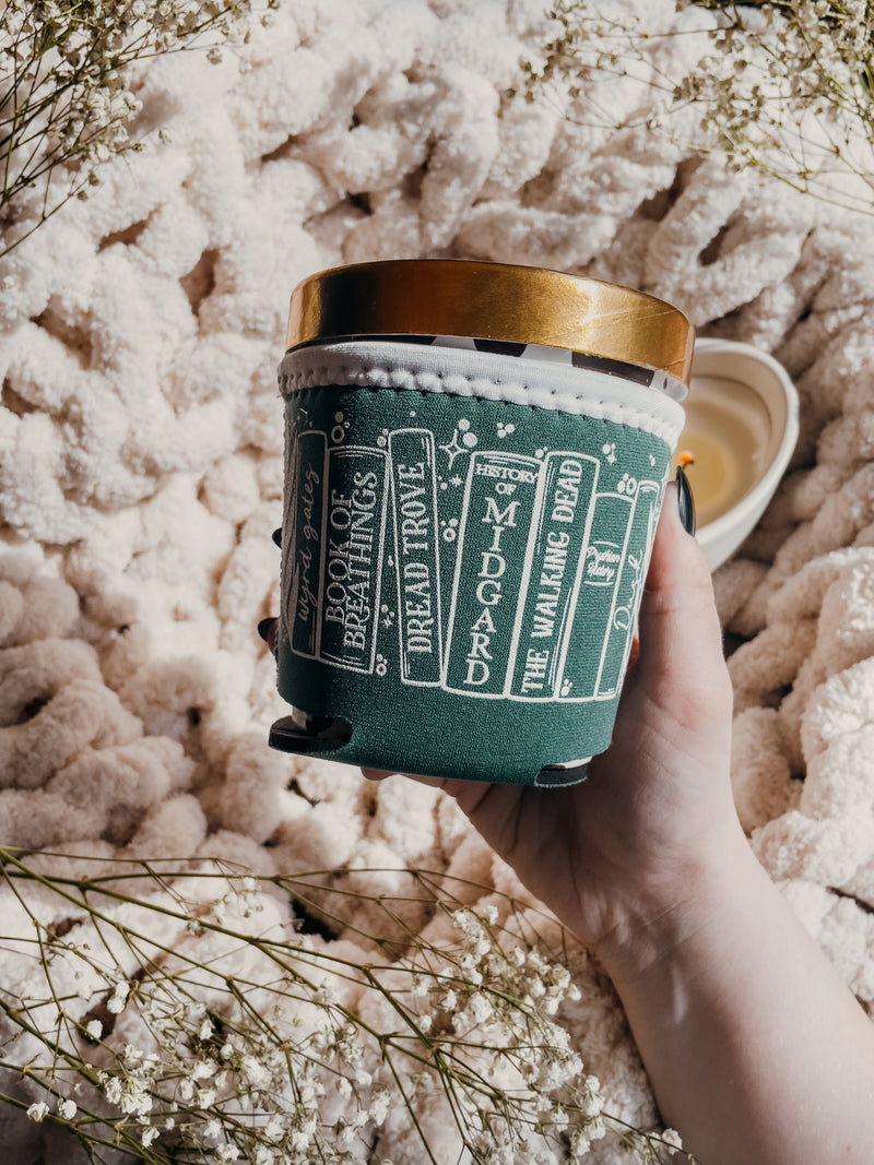 This ACOTAR / Throne of Glass / Crescent City ice cream pint sleeve is a dusty green with a white bookshelf design. Perfect for fans of Sarah J. Maas and a great gift for fantasy book lovers.