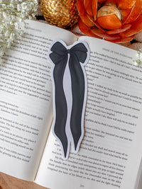 Black and Ivory Bow Die-Cut Bookmark placed on a book