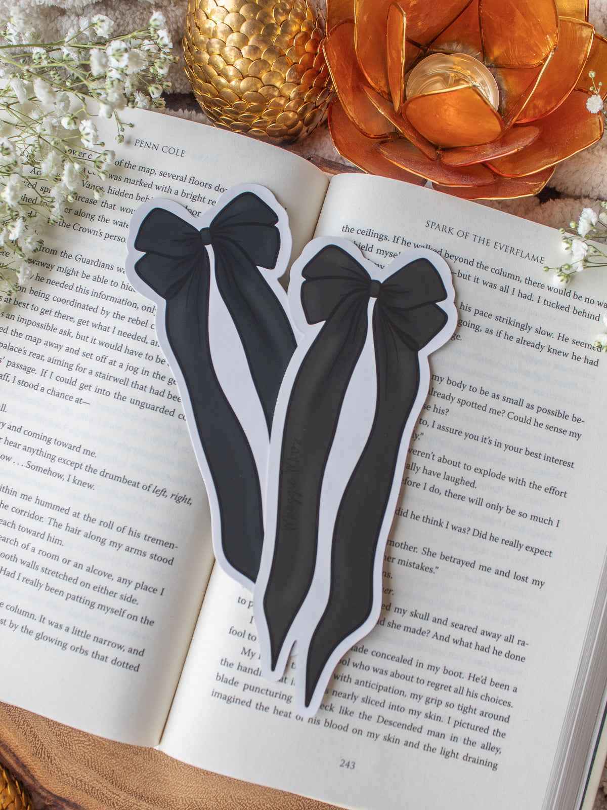 Black and Ivory Bow Die-Cut Bookmark placed on a book