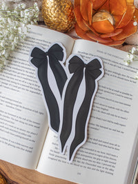 Black and Ivory Bow Die-Cut Bookmark placed on a book