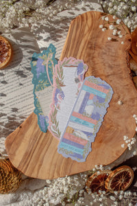 Bridgeton Inspired Die-Cut Bookmarks for Regency Era Romance Readers.

3 bookmarks, shown on a wood cutting board on top of an open book surrounded by orange slices, gold accents, and little white flowers.