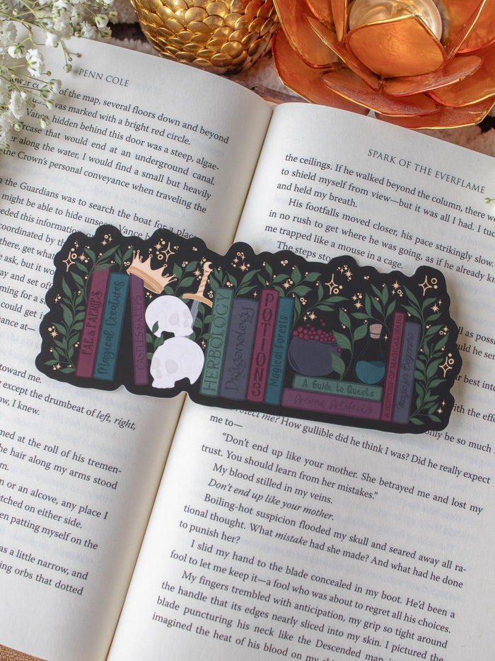 Dark Fantasy Reader Bookshelf Die-Cut Bookmark placed on a book