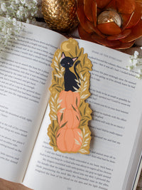 This adorable Fall / Autumn Pumpkin stack kitty cat bookmark has a deep chartreuse background, with a stack of 3 pumpkins and a little black kitty cat sitting on top. Surrounded by foliage and little stars. 