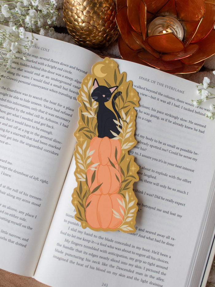This adorable Fall / Autumn Pumpkin stack kitty cat bookmark has a deep chartreuse background, with a stack of 3 pumpkins and a little black kitty cat sitting on top. Surrounded by foliage and little stars. 
