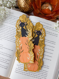 This adorable Fall / Autumn Pumpkin stack kitty cat bookmark has a deep chartreuse background, with a stack of 3 pumpkins and a little black kitty cat sitting on top. Surrounded by foliage and little stars. 