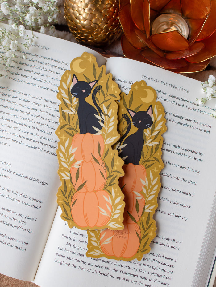 This adorable Fall / Autumn Pumpkin stack kitty cat bookmark has a deep chartreuse background, with a stack of 3 pumpkins and a little black kitty cat sitting on top. Surrounded by foliage and little stars. 