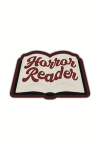 An open book with "Horror Reader" written on in in a retro script. Sticker shown on a white background