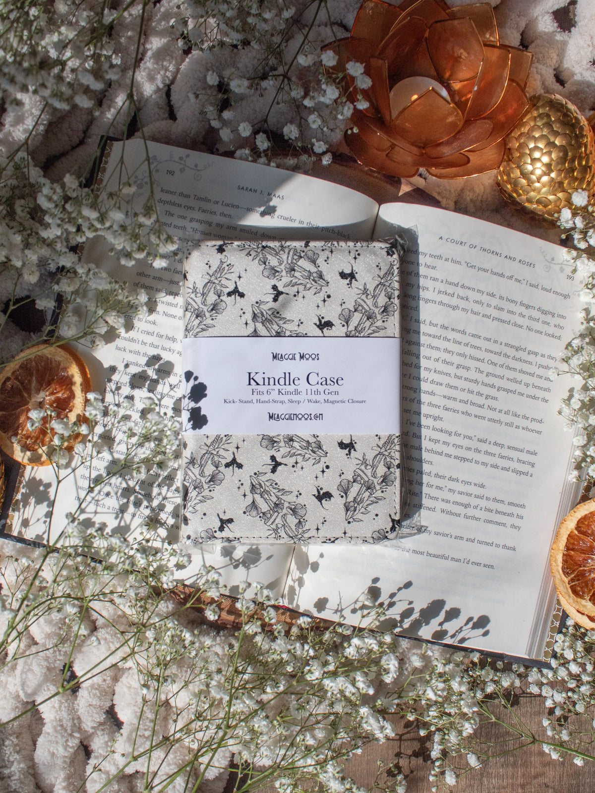 Ivory Swords Fantasy Reader Dragon Kindle Case. It has an ivory background with deep charcoal dragons, swords, crowns, and foliage all over it. This is a full cover kindle case with a leatherette outside, a kick-stand, card-slot, and hand-strap. 