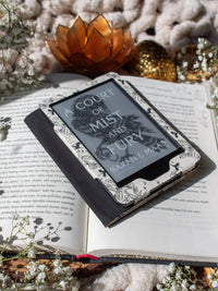 Ivory Swords Fantasy Reader Dragon Kindle Case. It has an ivory background with deep charcoal dragons, swords, crowns, and foliage all over it. This is a full cover kindle case with a leatherette outside, a kick-stand, card-slot, and hand-strap. 