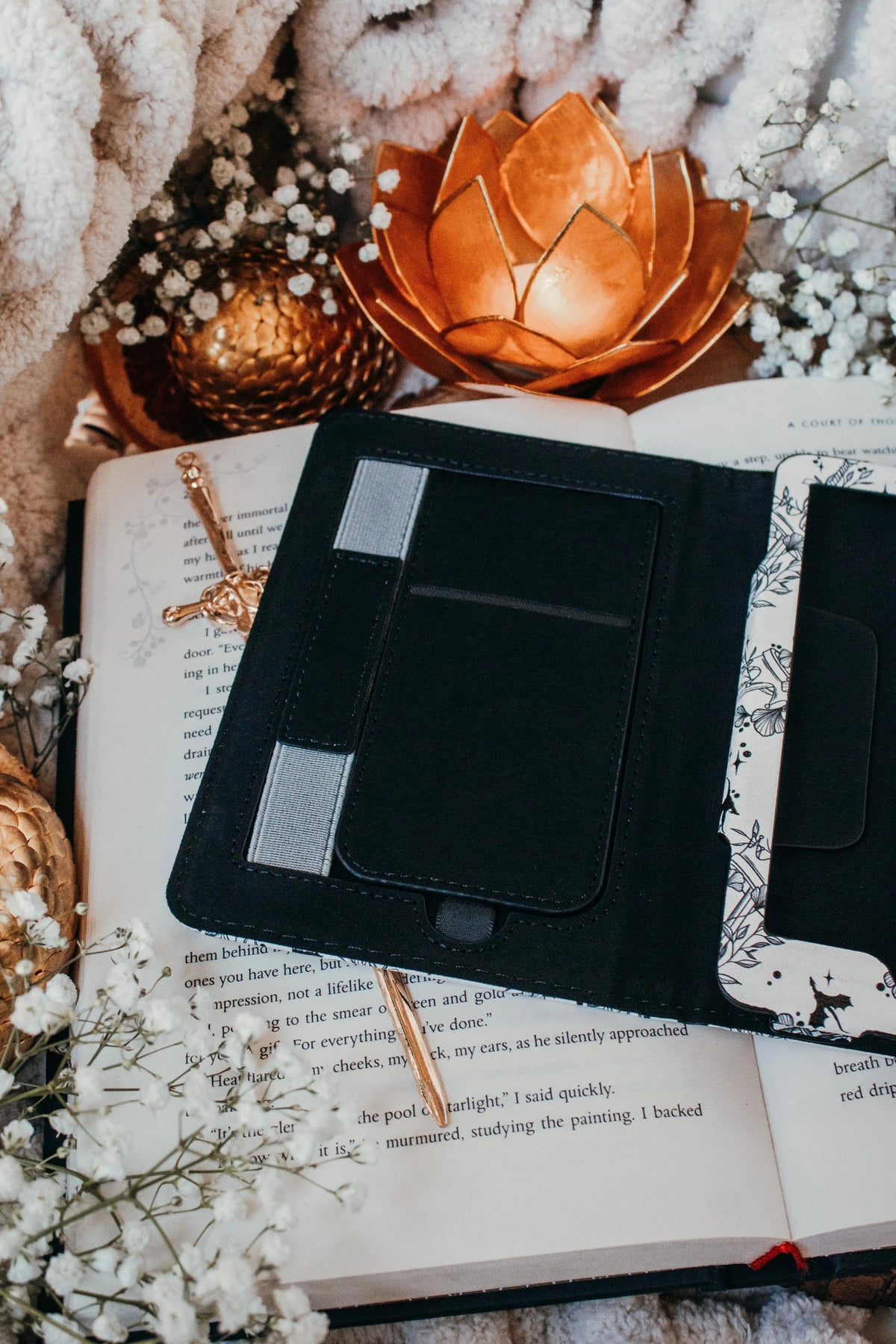 Ivory Swords Fantasy Reader Dragon Kindle Case. It has an ivory background with deep charcoal dragons, swords, crowns, and foliage all over it. This is a full cover kindle case with a leatherette outside, a kick-stand, card-slot, and hand-strap. 