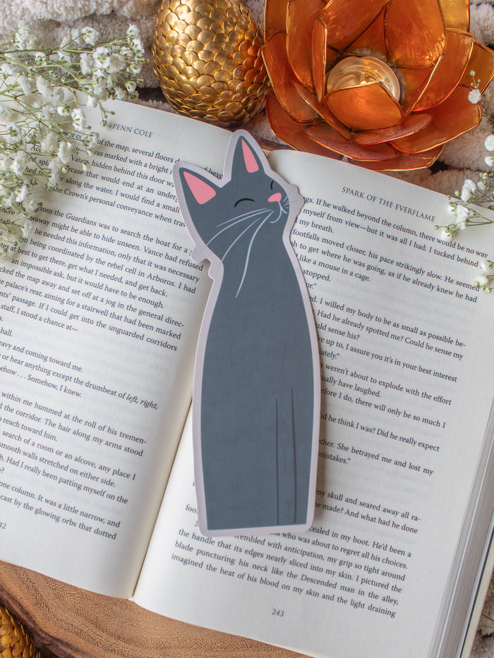 Little Grey Kitty Cat Die-Cut Bookmark on a book with baby's breath and other decorative elements around it.