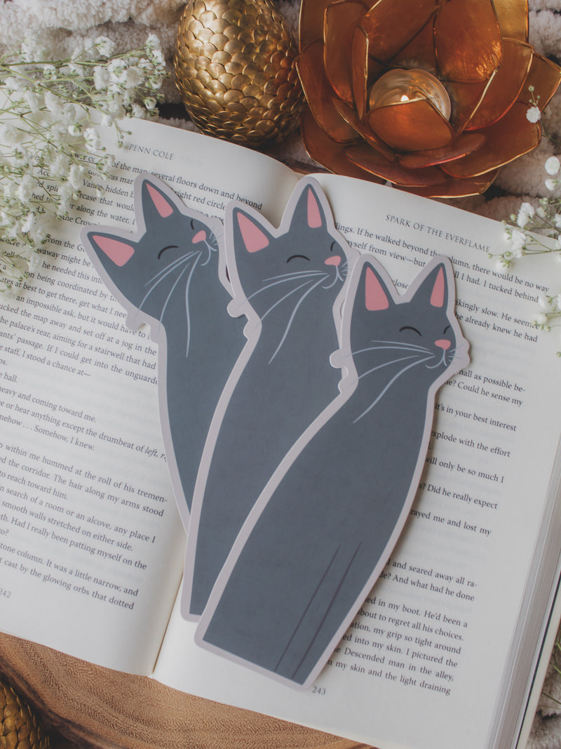 Little Grey Kitty Cat Die-Cut Bookmark on a book with baby's breath and other decorative elements around it.