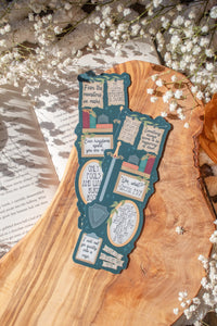 Bookmark inspired by the novel by Devney Perry. This bookmark is dark teal with frames on it with a bunch of different quotes from the book.

The bookmark is laid on an olive wood cutting board, sitting on an open book with little white flowers surrounding it.