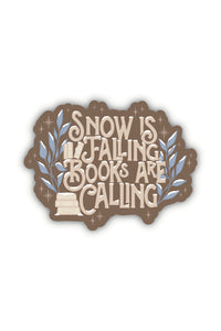 This "Snow is Falling, Books are Calling" winter bookish sticker has the text in a fun font in a light taupe on a dark taupe background surrounded by snow covered light blue foliage and stars.