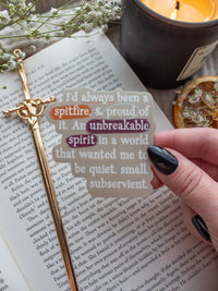 Spark of The Everflame "I'd always been a spitfire, and proud of it. An unbreakable spirit in a world that wanted me to be quiet, small, subservient." quote. Inspired from the novel from The Kindred's Curse Saga by Penn Cole, this officially licensed sticker has a camel background, with white type-writer style text and annotation like highlighting, circling, and underlining. 