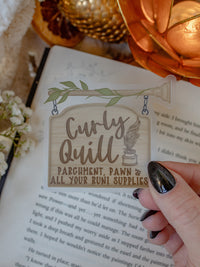 This bookish Curly Quill Sign sticker from When The Moon Hatched by Sarah A Parker is on a clear background. 