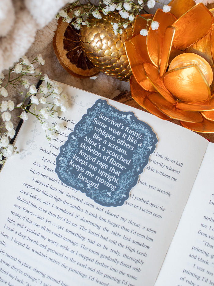 This officially licensed When the Moon Hatched Sticker is slate blue with cream text, and an ivy boarder with little stars, magic bubbles and dragons flying around.