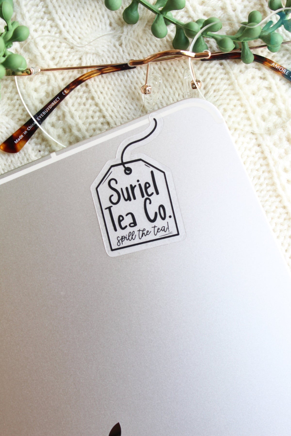 This little Suriel Tea Co Tea Bag Sticker from A Court of Thorns and Roses by Sarah J Maas is perfect for any ACOTAR Fan to show off their love of the series in a subtle way. It is all black on a clear background and it looks like a small tea bag with the text "Suriel Tea Co - Spill the Tea!" on it. 