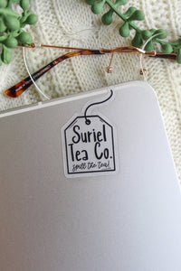 This little Suriel Tea Co Tea Bag Sticker from A Court of Thorns and Roses by Sarah J Maas is perfect for any ACOTAR Fan to show off their love of the series in a subtle way. It is all black on a clear background and it looks like a small tea bag with the text "Suriel Tea Co - Spill the Tea!" on it. 