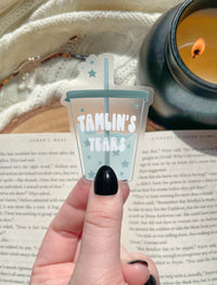 This ACOTAR Tamlin's Tears Tumbler Sticker from A Court of Thorns and Roses by Sarah J Maas is a light blue/ teal tumbler with the text "Tamlin's Tears" in a white bubble font. Transparent Background. 