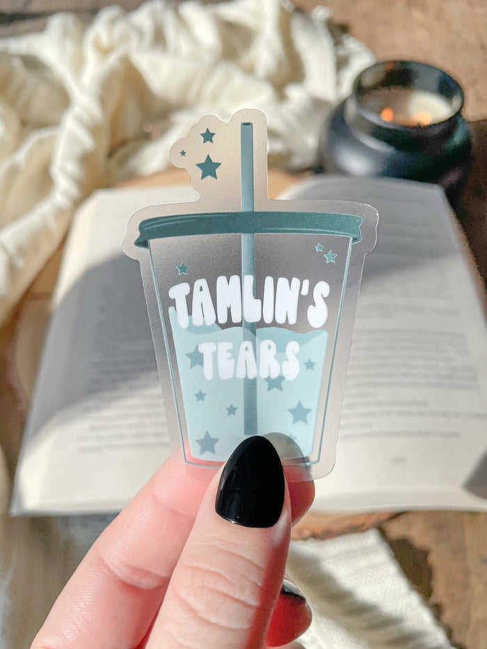 This ACOTAR Tamlin's Tears Tumbler Sticker from A Court of Thorns and Roses by Sarah J Maas is a light blue/ teal tumbler with the text "Tamlin's Tears" in a white bubble font. Transparent Background. 