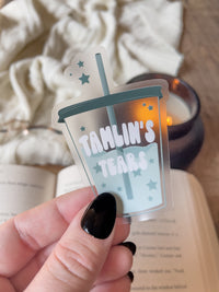This ACOTAR Tamlin's Tears Tumbler Sticker from A Court of Thorns and Roses by Sarah J Maas is a light blue/ teal tumbler with the text "Tamlin's Tears" in a white bubble font. Transparent Background. 