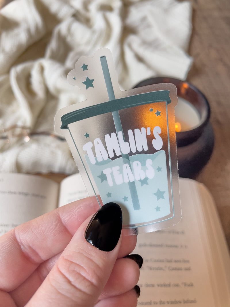 This ACOTAR Tamlin's Tears Tumbler Sticker from A Court of Thorns and Roses by Sarah J Maas is a light blue/ teal tumbler with the text "Tamlin's Tears" in a white bubble font. Transparent Background. 