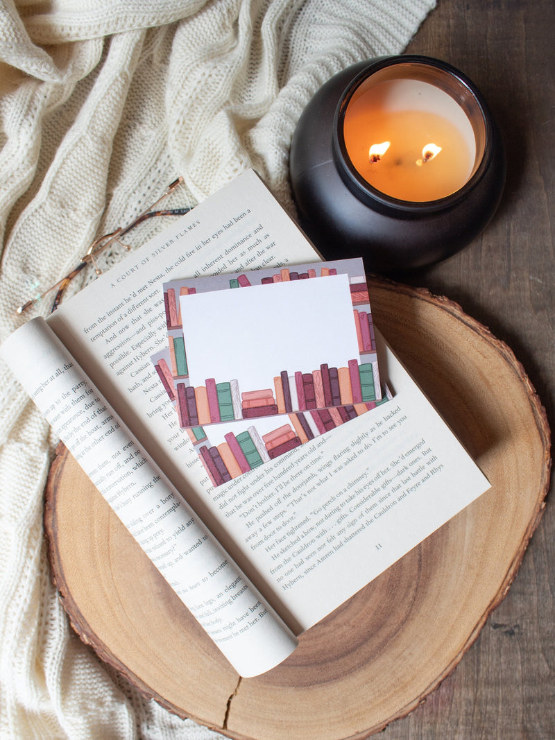 This autumn bookshelf post-it notepad features a bookshelf in autumnal tones, and a white place in the center to write on. 
