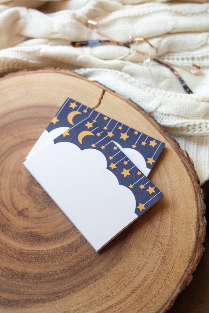 These Midnight Dreams Post-It Notepads are 3"x4" and have a cloud (where you write) below a night sky with stars and a moon hanging from lil strings