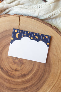 These Midnight Dreams Post-It Notepads are 3"x4" and have a cloud (where you write) below a night sky with stars and a moon hanging from lil strings